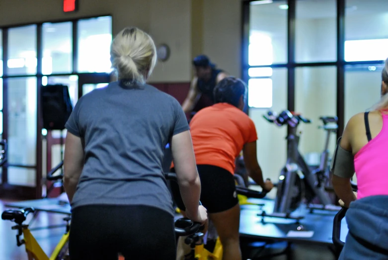 people working out in a gym with exercise bikes