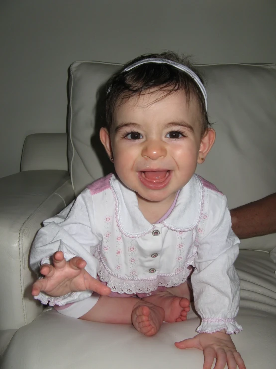 a baby girl that is sitting on the floor