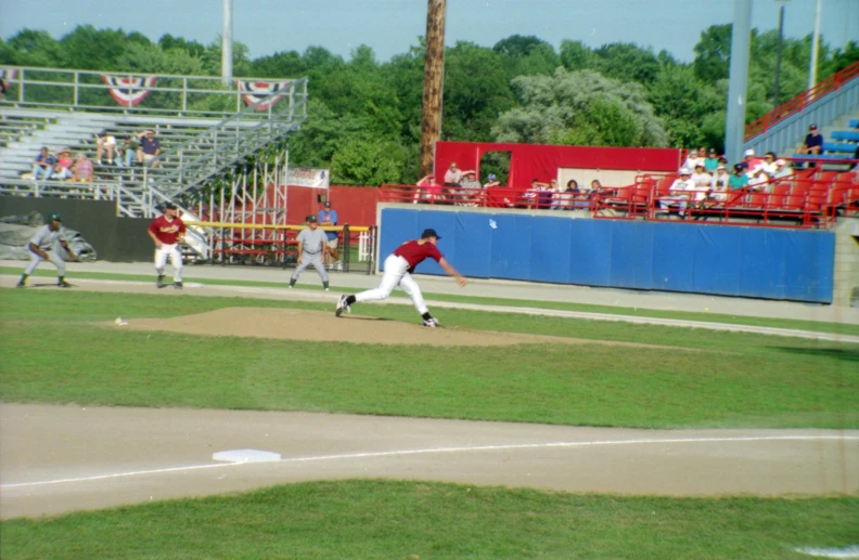 some players are playing baseball on a field