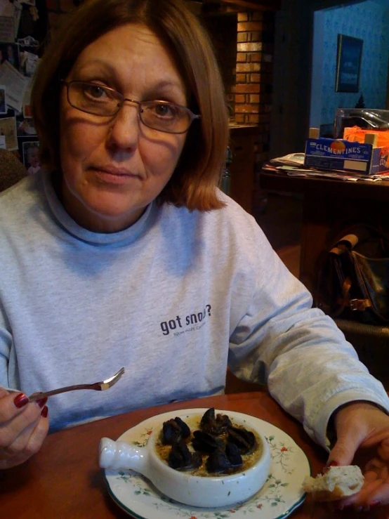 a woman is eating some food on the table