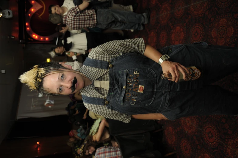 a woman with duct tape on her face, in overalls and a tie