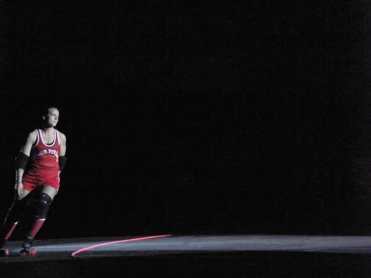 a girl in a red uniform is on her skateboard