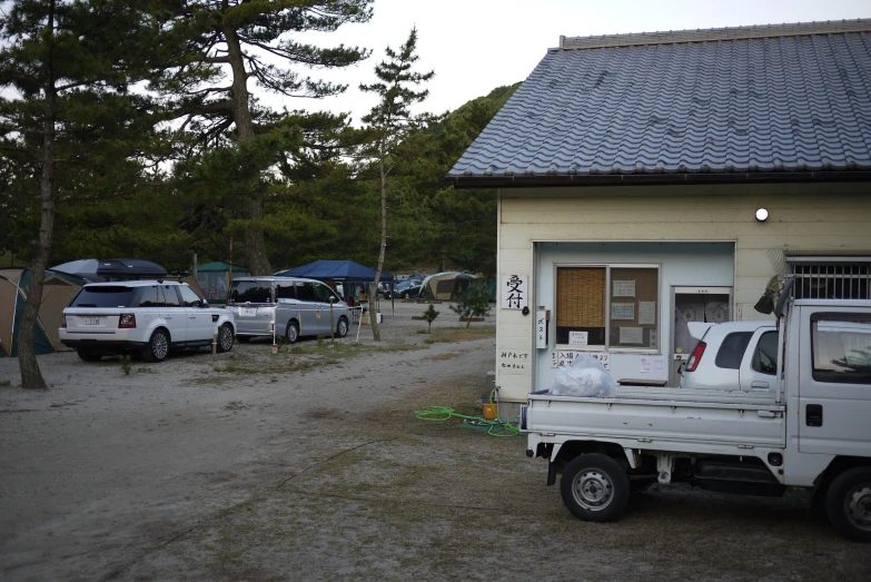 an old truck parked next to a small house