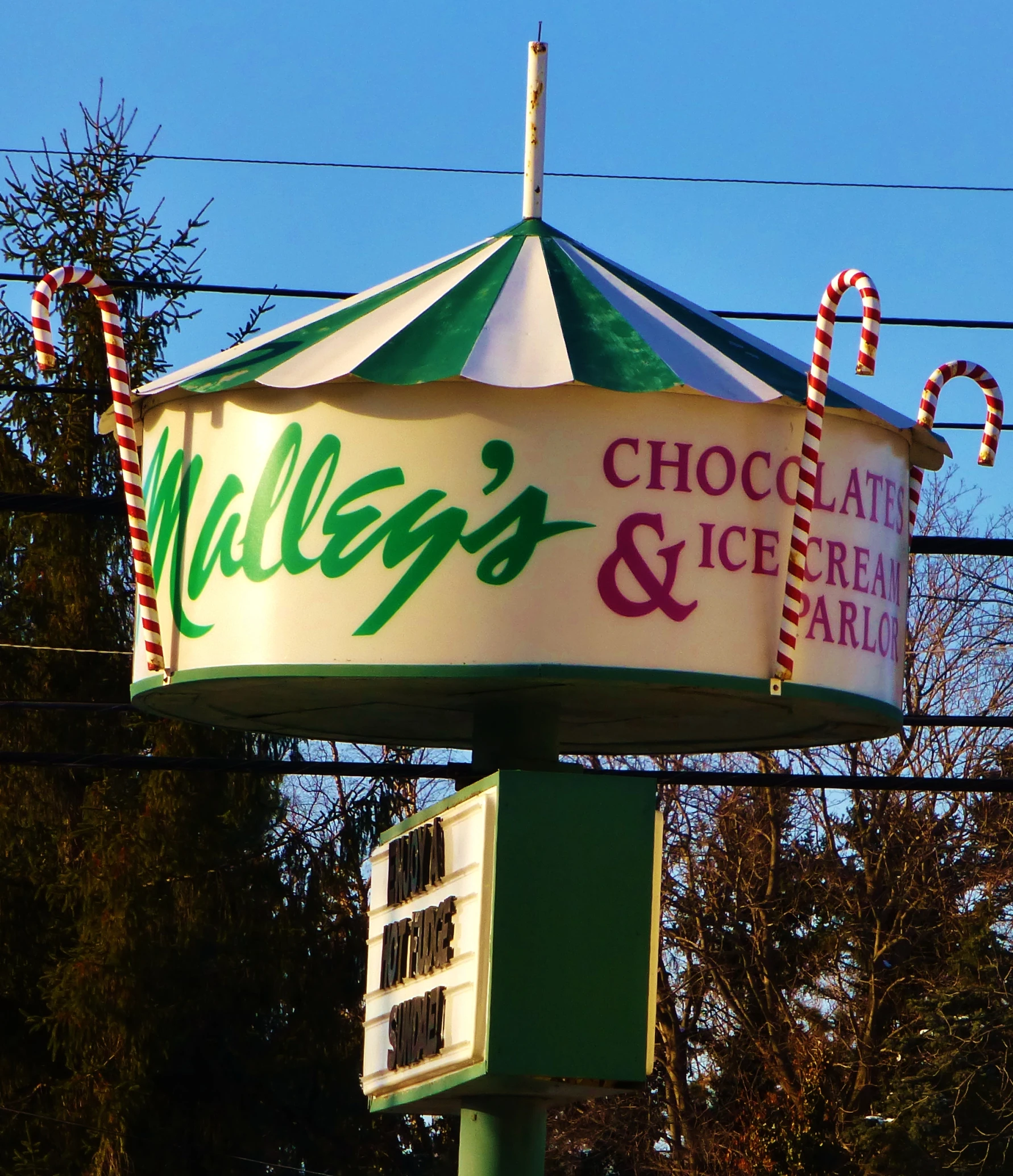 a large piece of food is displayed above a large sign