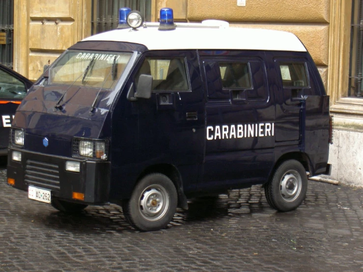 the blue van is parked beside another car