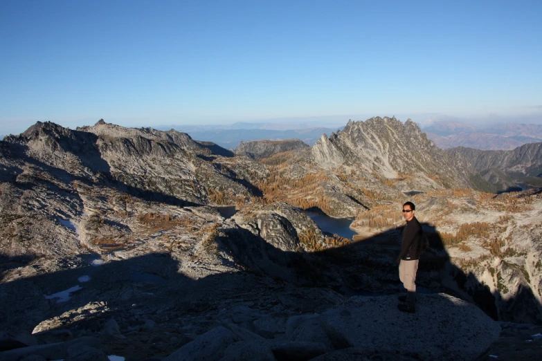 man standing on a rock and taking po