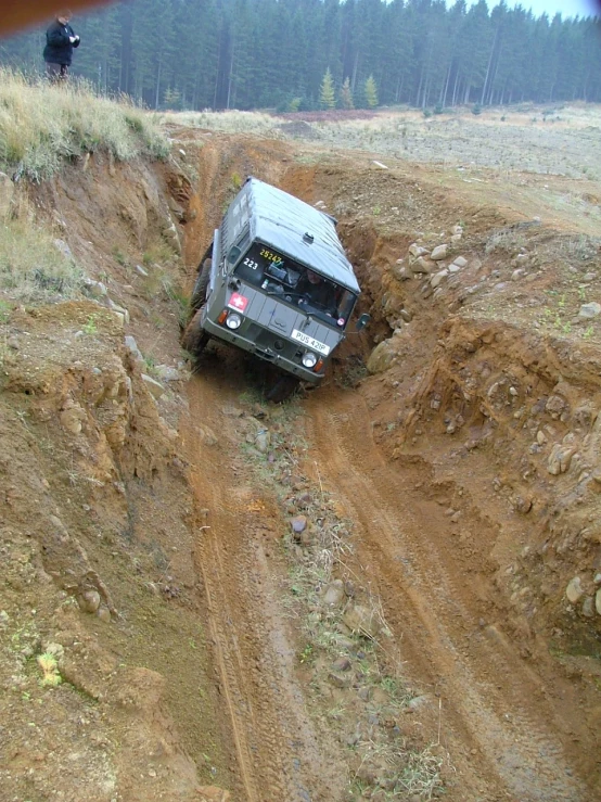 a truck on top of a dirt trail on an overcast day