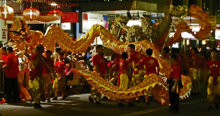 a large group of people are dressed in yellow and red