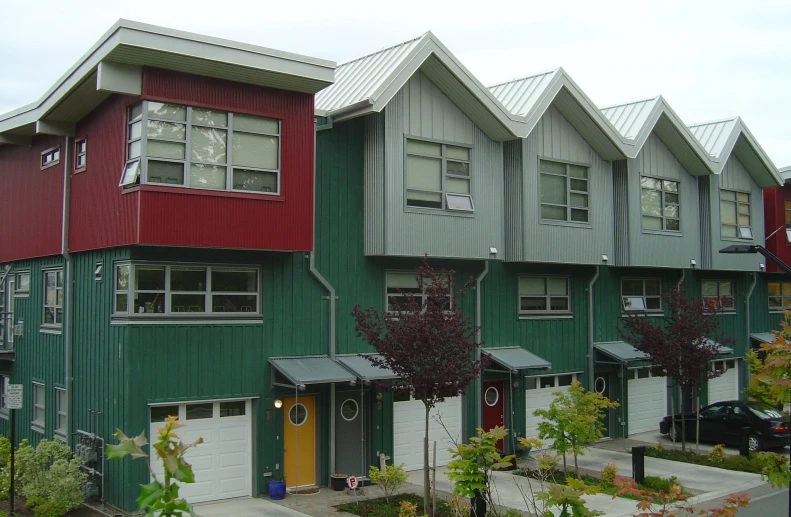 a row of apartment buildings painted green and red