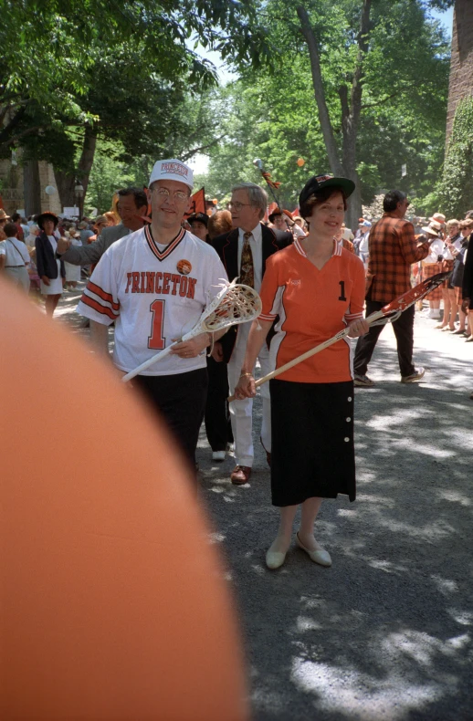 people walking down the street while holding hands