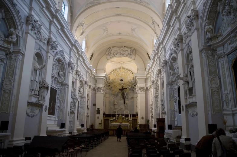 a person walking down a large church hall