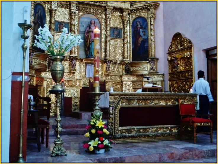 a alter with a bunch of flowers in a church
