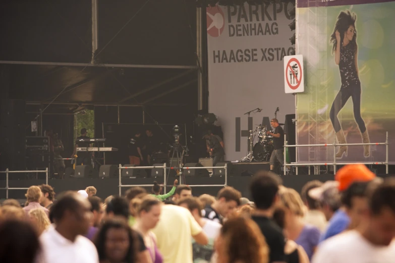 a group of people standing in front of a big screen