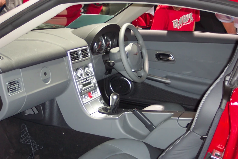 the inside of a silver car with the door open