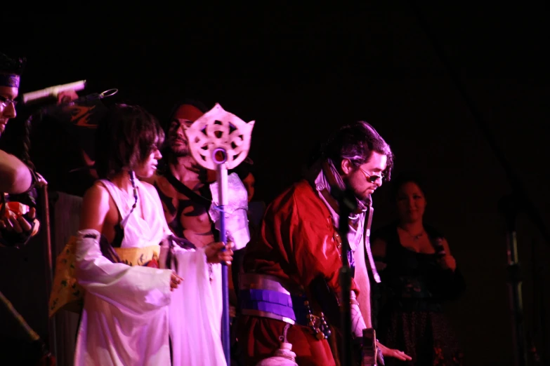 a couple dressed up as characters with instruments at a concert