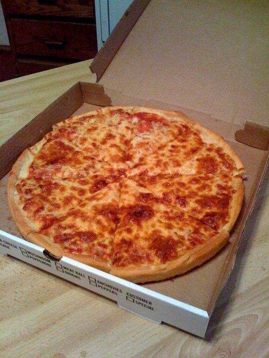 a large cheese pizza in a box on a table