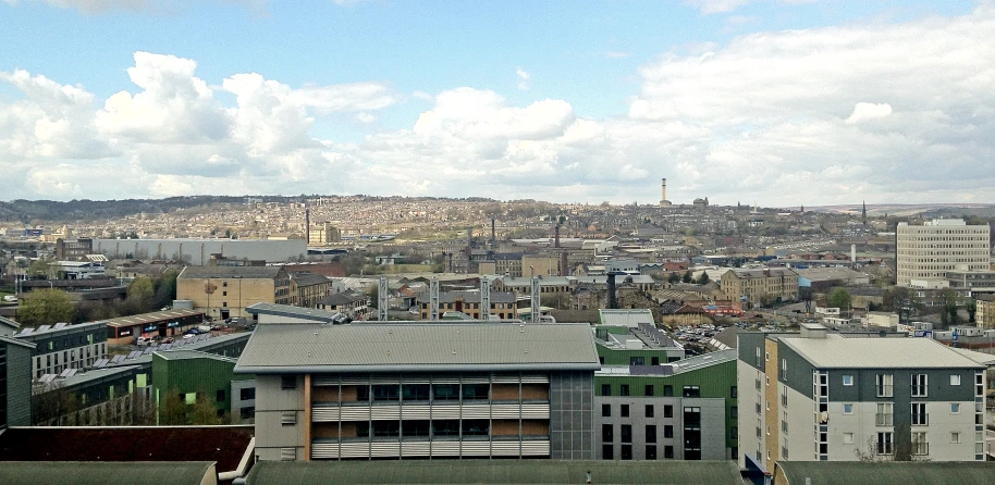 a city with buildings in the distance, and some hills in the background