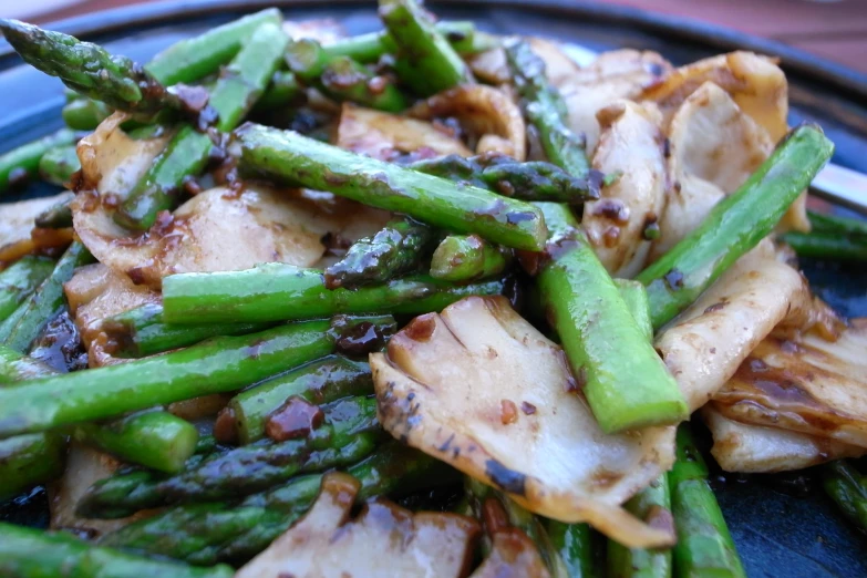 a plate topped with green beans and chicken