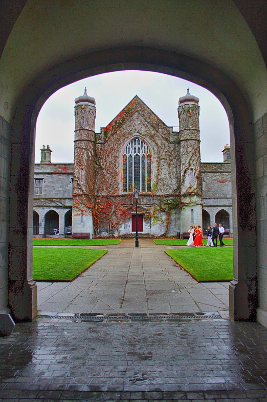 a view looking through the arches towards an old brick building