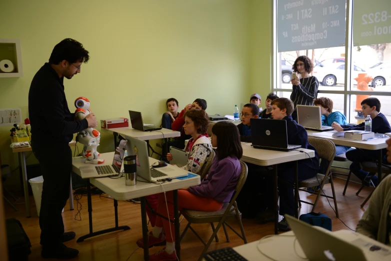 a man standing in front of a classroom filled with students