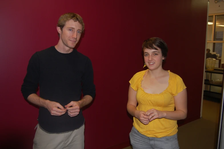 the couple are standing together in the room