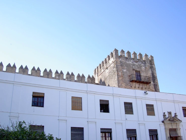 the building has a tower with a balcony above it