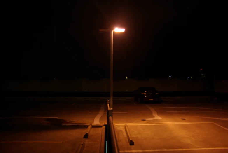 a parking lot with cars parked at night time