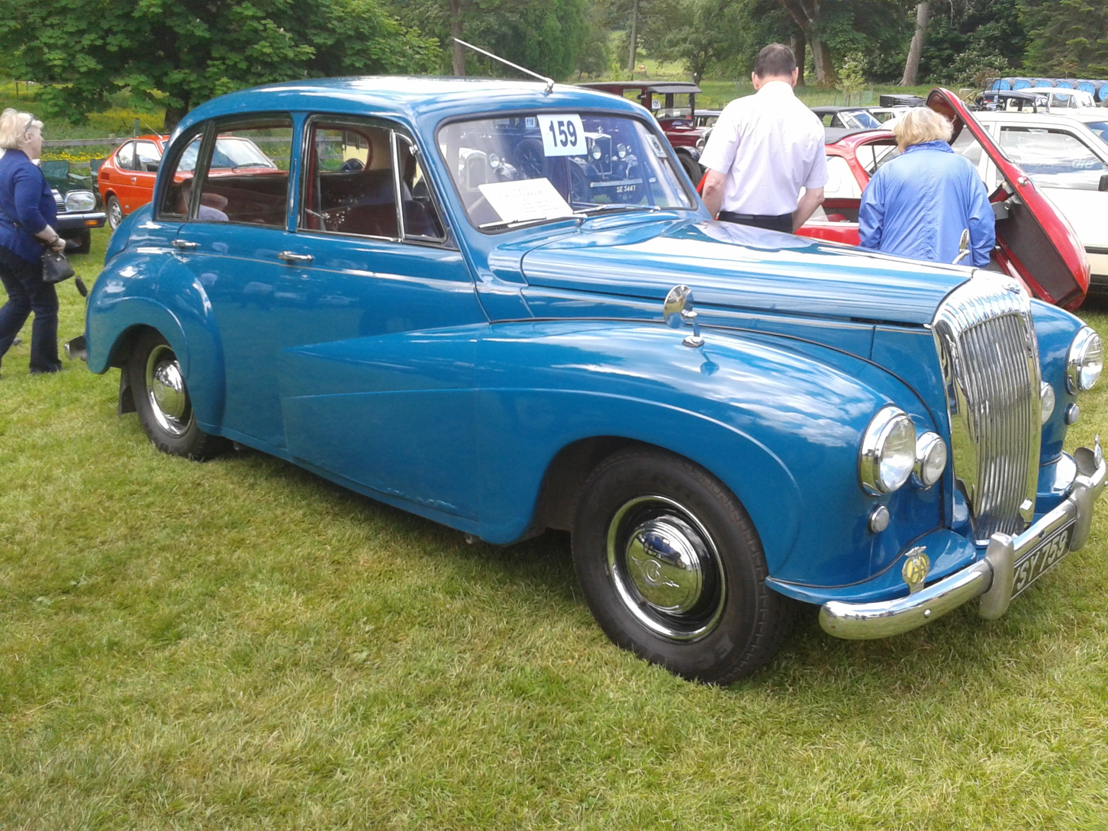 some people are looking at an old car