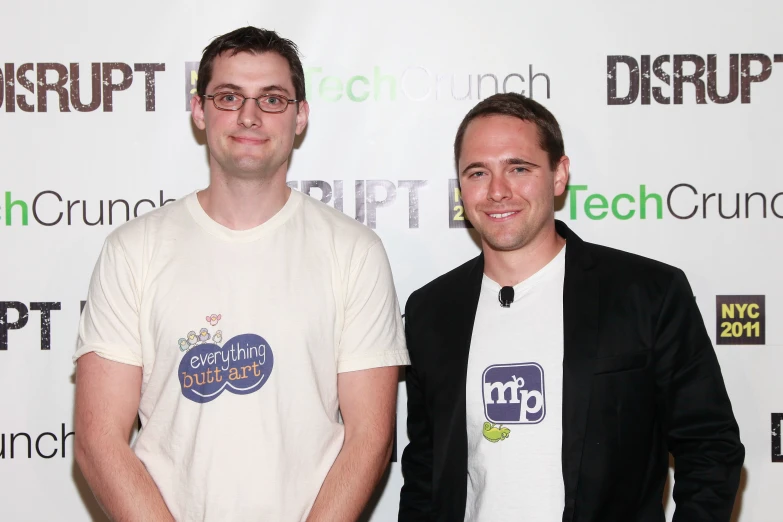 two men pose for the camera at a tech launch