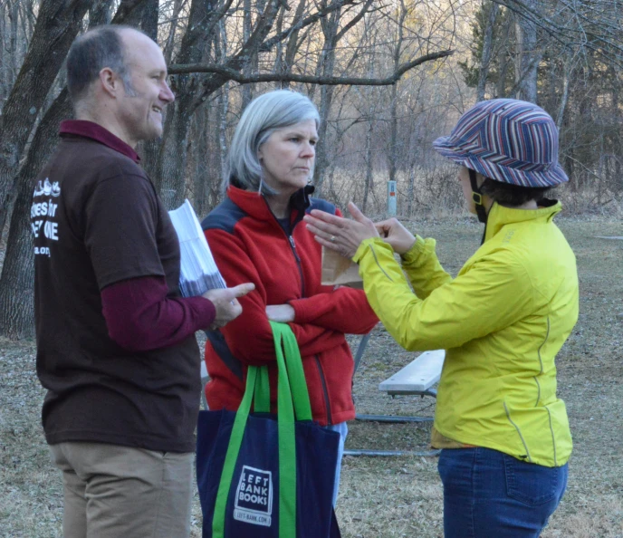 a group of people stand and talk outside