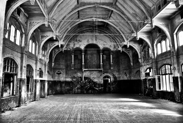 an empty building with several pillars and arches