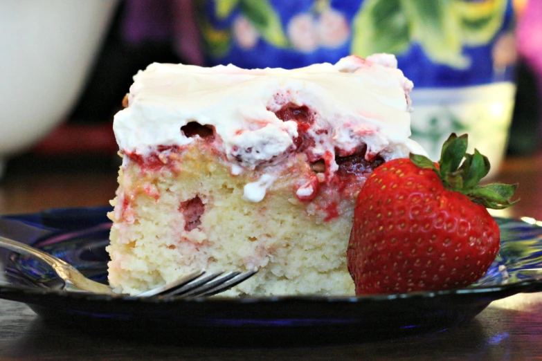 a piece of cake and strawberry on a plate