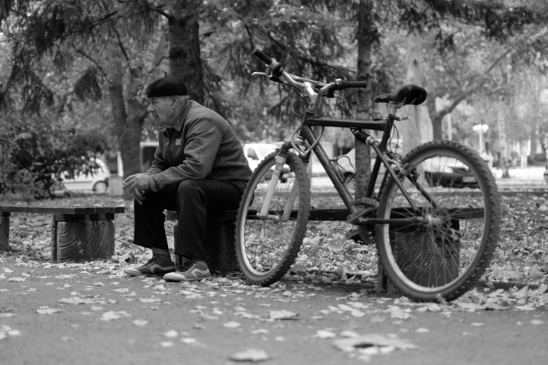 a man sits next to his bike on the ground