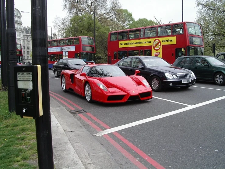 two red cars parked side by side in the road