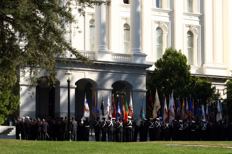 the group of military men standing at attention for a ceremony