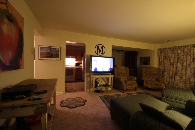 a living room filled with furniture and a tv