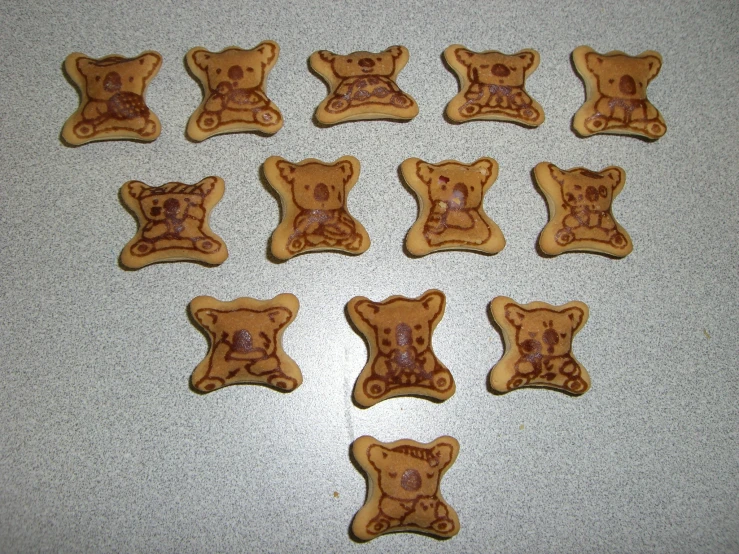 cookies are arranged in the shape of bear's heads and paws