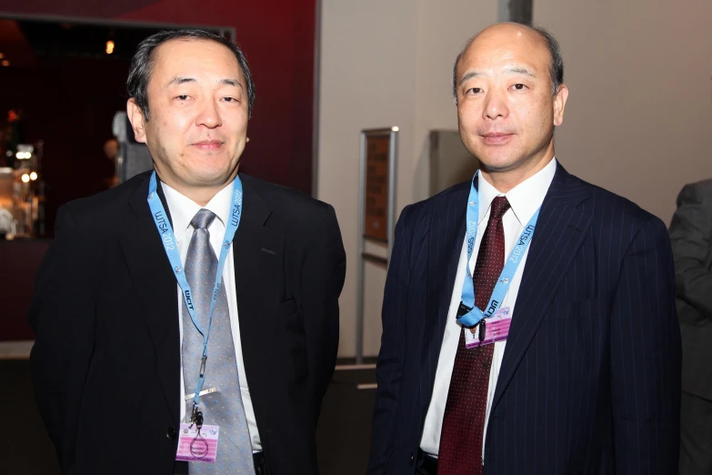 two men are dressed up for a business event