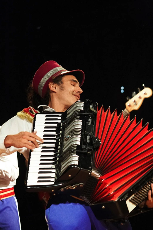 a man playing an accordion in the dark