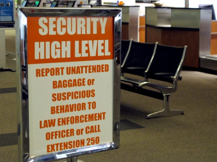 a sign in an airport stating security high level