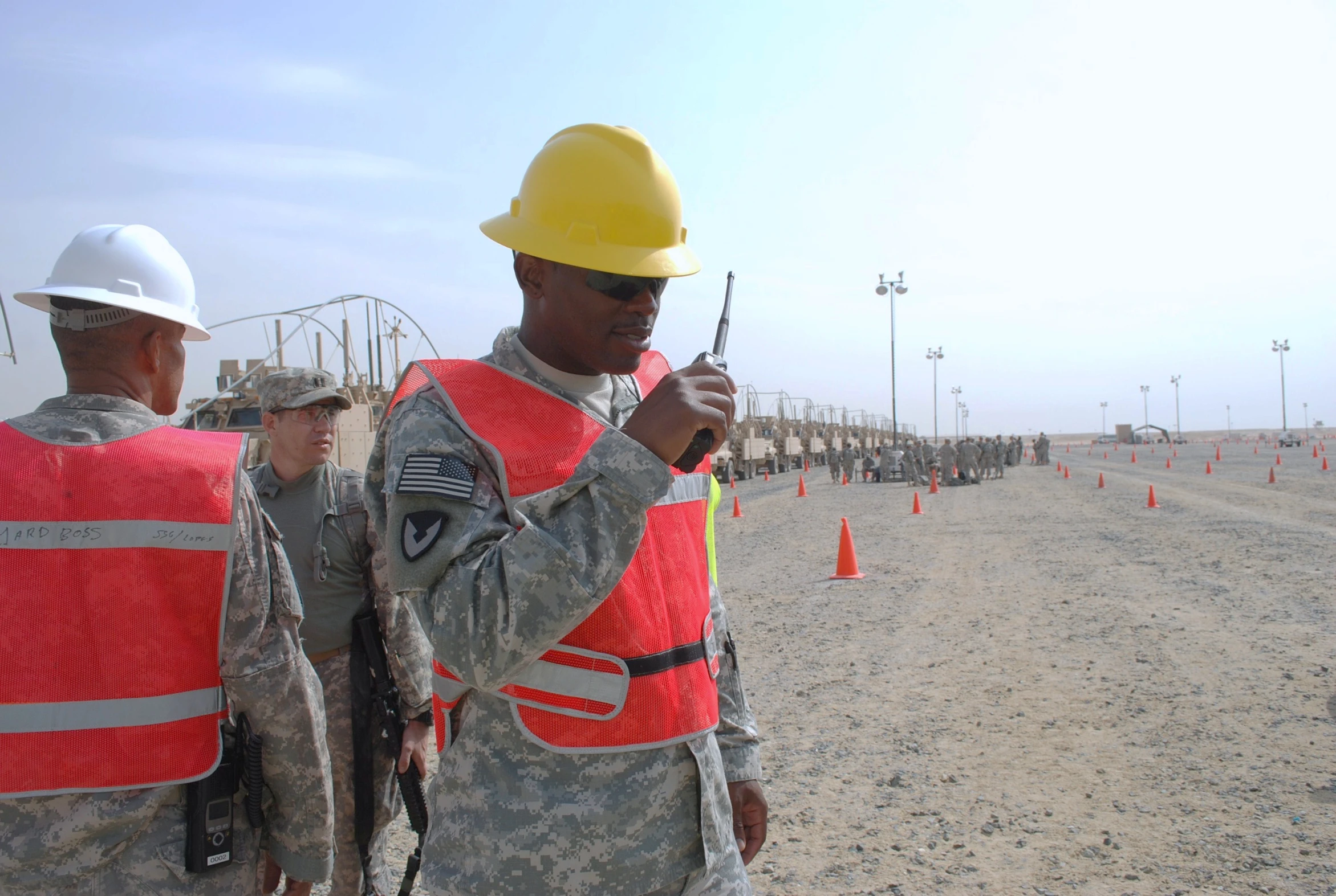 two men with yellow helmets and reflective vests