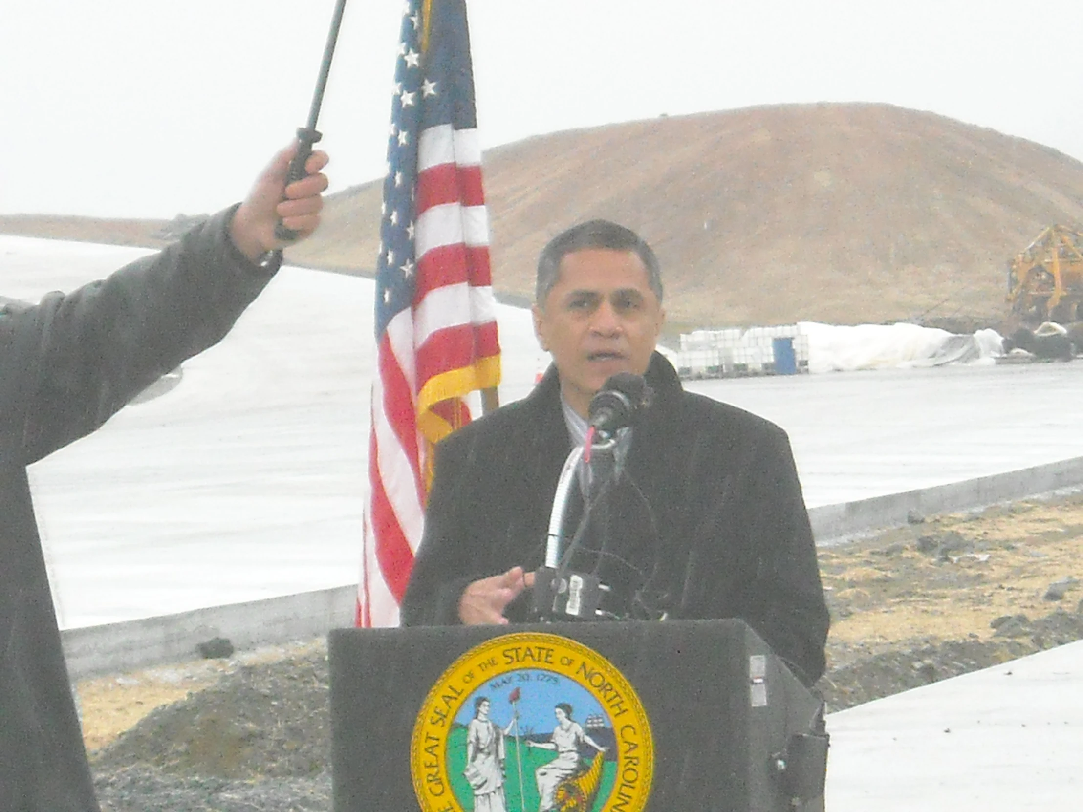 a man giving a speech in front of a podium