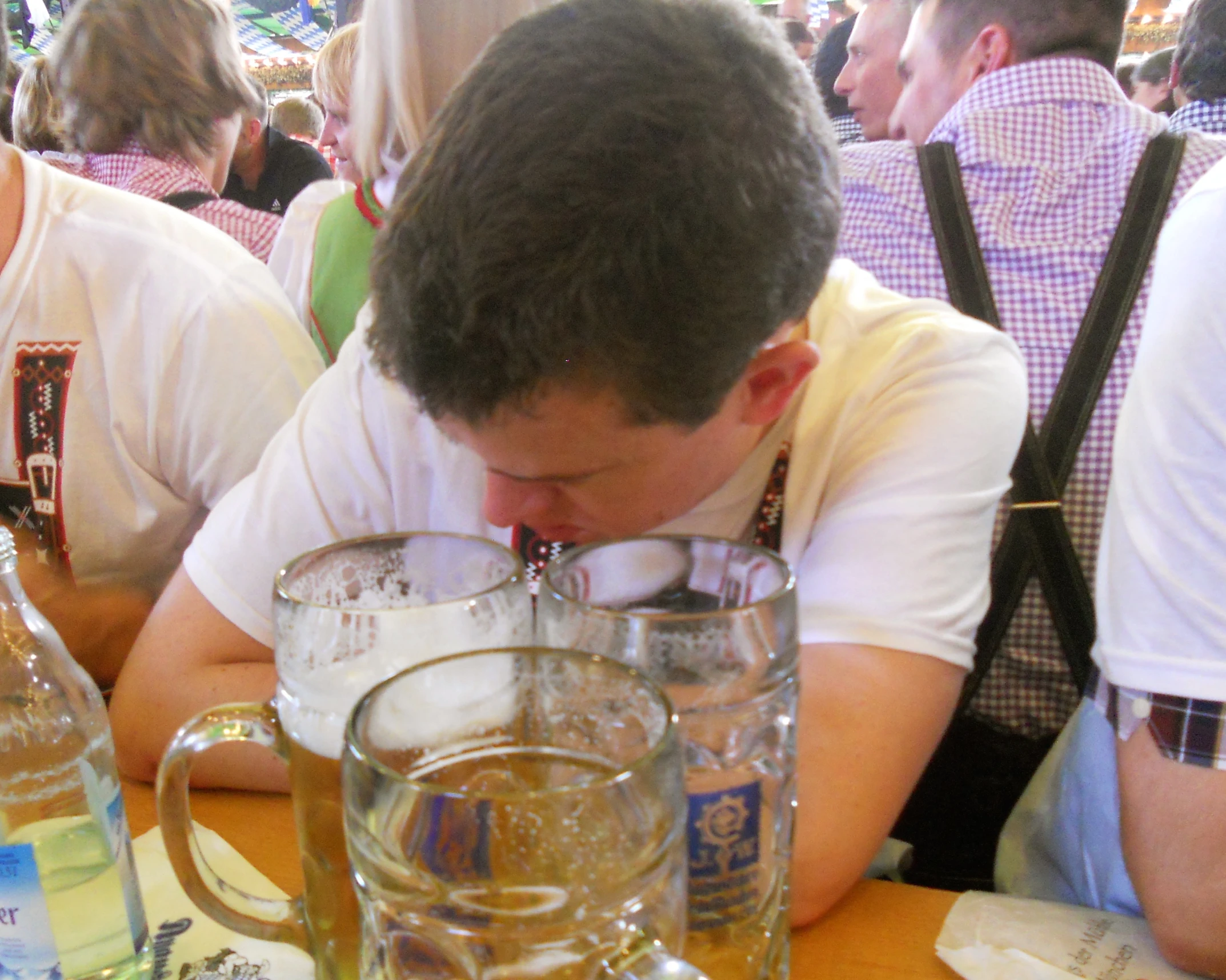 a man sitting at a table with beer