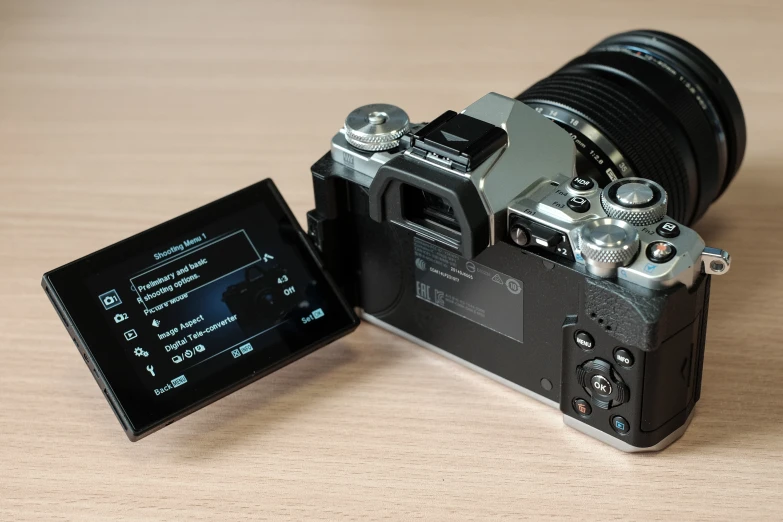 a camera next to a digital card on a table