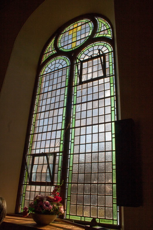 there is a large stained glass window with flowers on the table