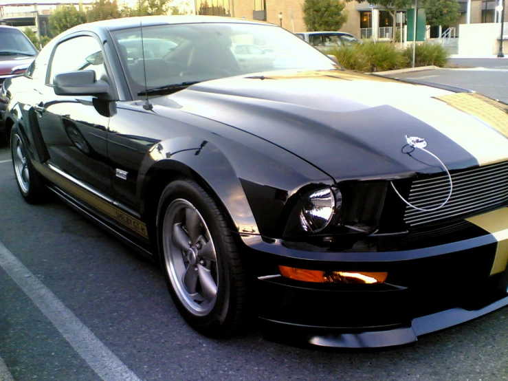 black mustang car parked in a parking space with yellow stripes