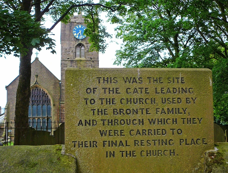 a stone structure with a statue of a building and church next to it