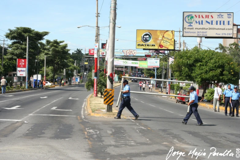 three men walking across the street with no cars