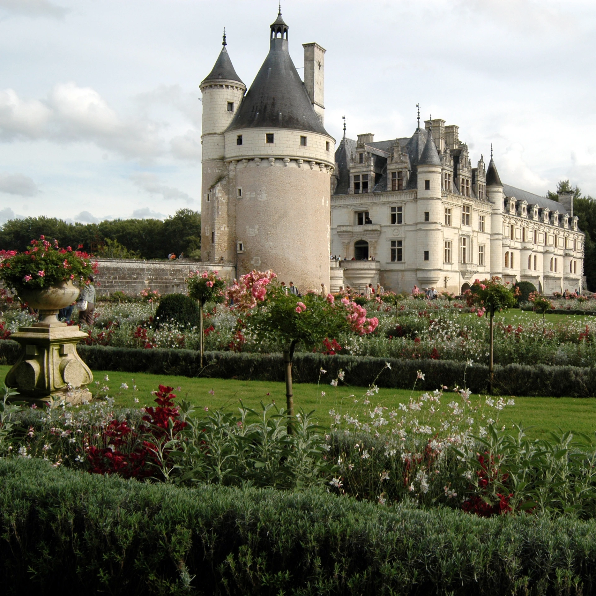 a castle with towers and gardens surrounding it