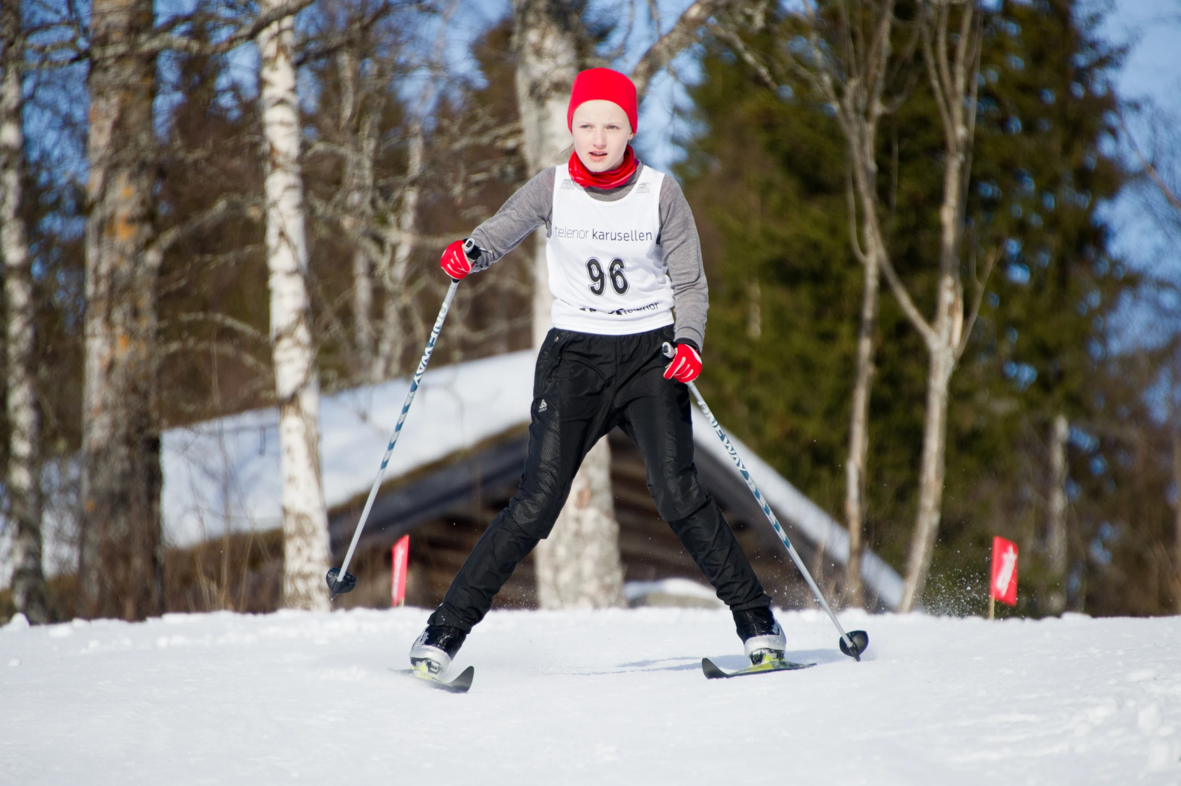 a young person riding skis down the side of a snow covered slope